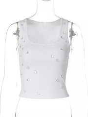 White ribbed cropped tank top with scattered rhinestones and square neckline.