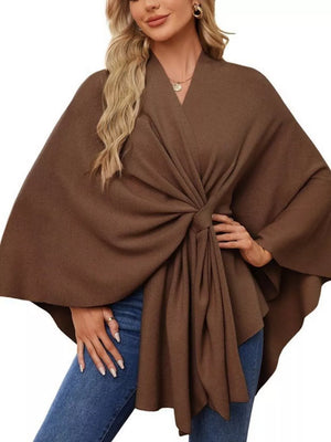 Knit cape top in caramel with V-neck and tie-front detail, styled with jeans.