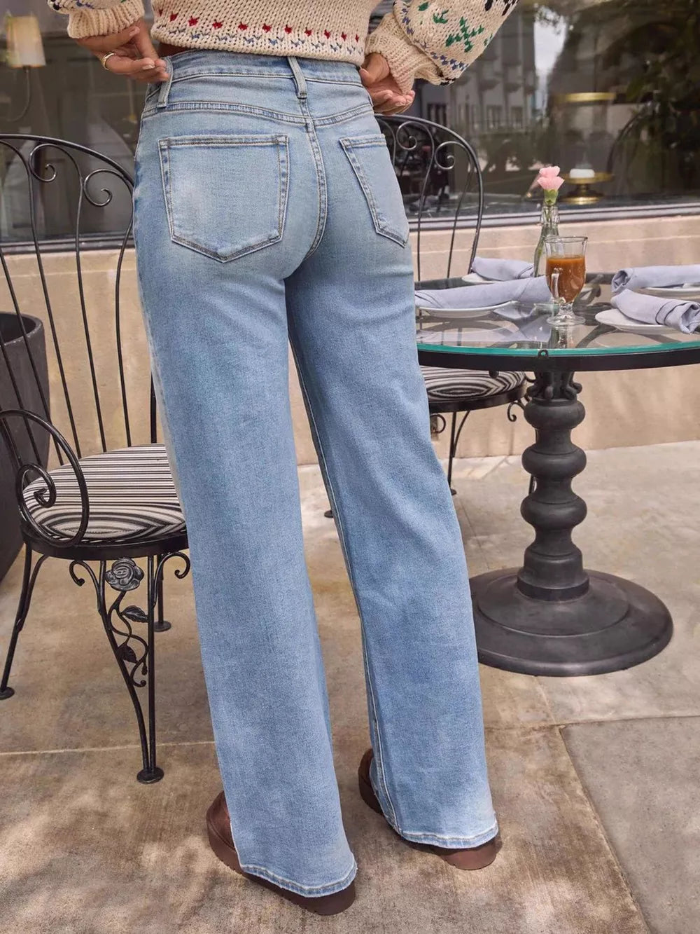Light blue denim high-waisted wide-leg jeans with button closure.