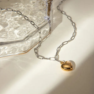 Two-tone heart chain necklace with a gold heart charm and silver chain.