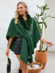 Dark green faux fur collar wrap poncho with tie closure and pom-pom detail.