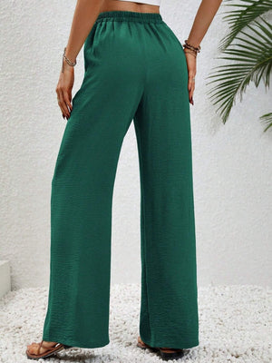 Dark green textured palazzo trousers with drawstring waist and wide legs.