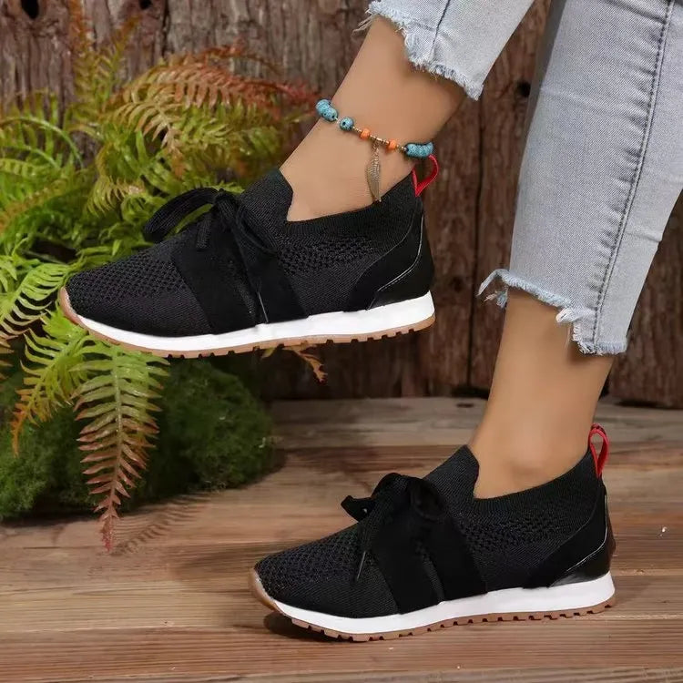 Black knit & suede lace-up sneakers with white soles and red heel tab.