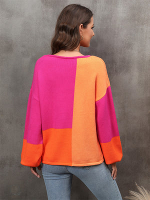Colorblock balloon sleeve knit sweater in hot pink and orange acrylic with a crew neck.
