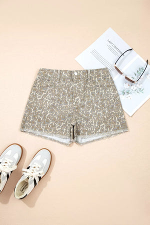 Denim shorts with leopard print and frayed hem, styled with sneakers and sunglasses.