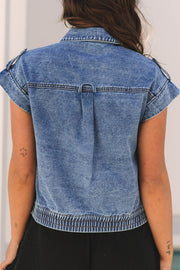 Boxy denim vest in medium wash cotton with shoulder detail and elasticized hem.