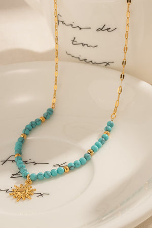 Gold celestial sunburst beaded necklace with turquoise beads and gold accents