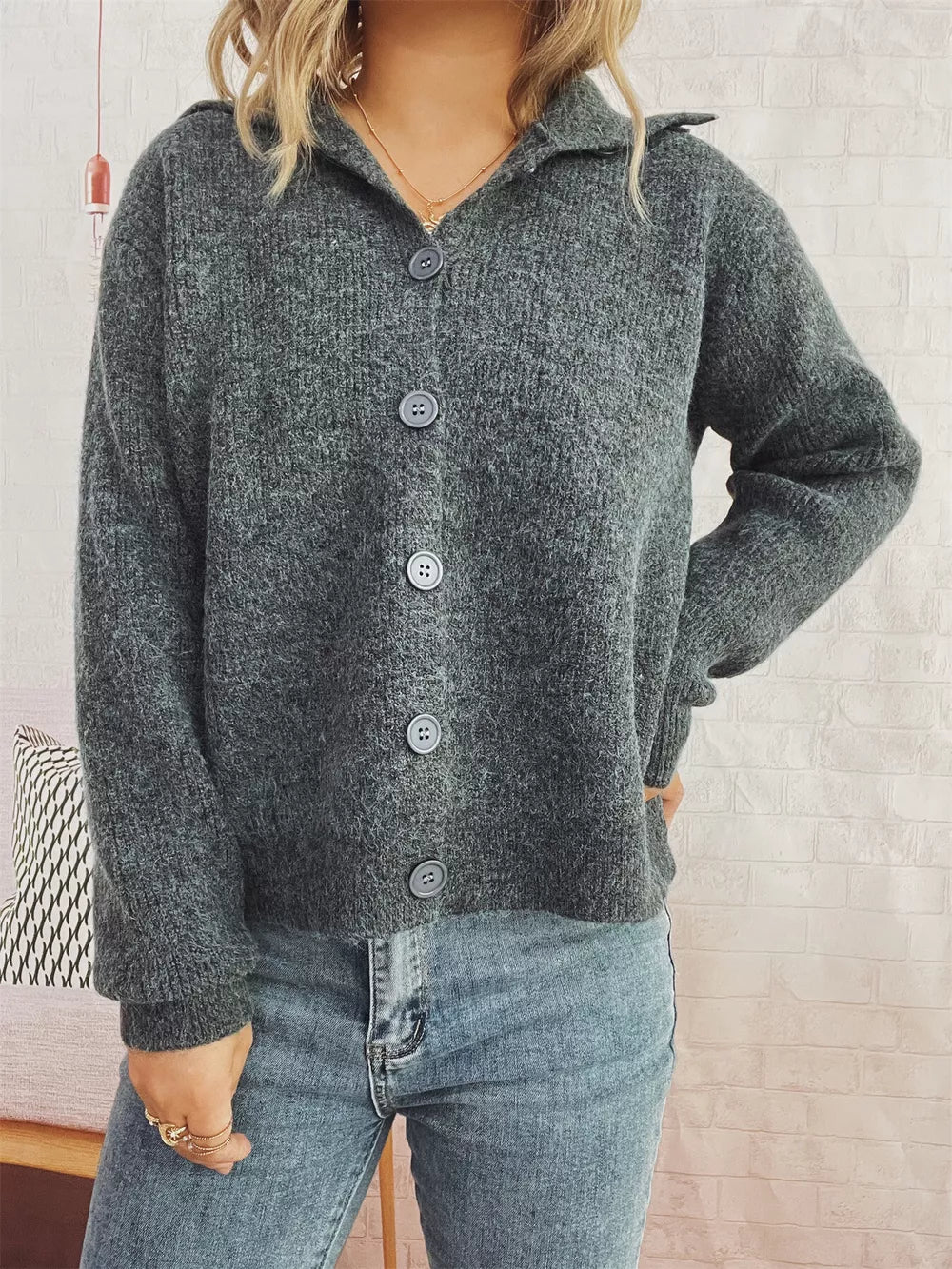 Gray ribbed knit cardigan with polo collar and button-up front.