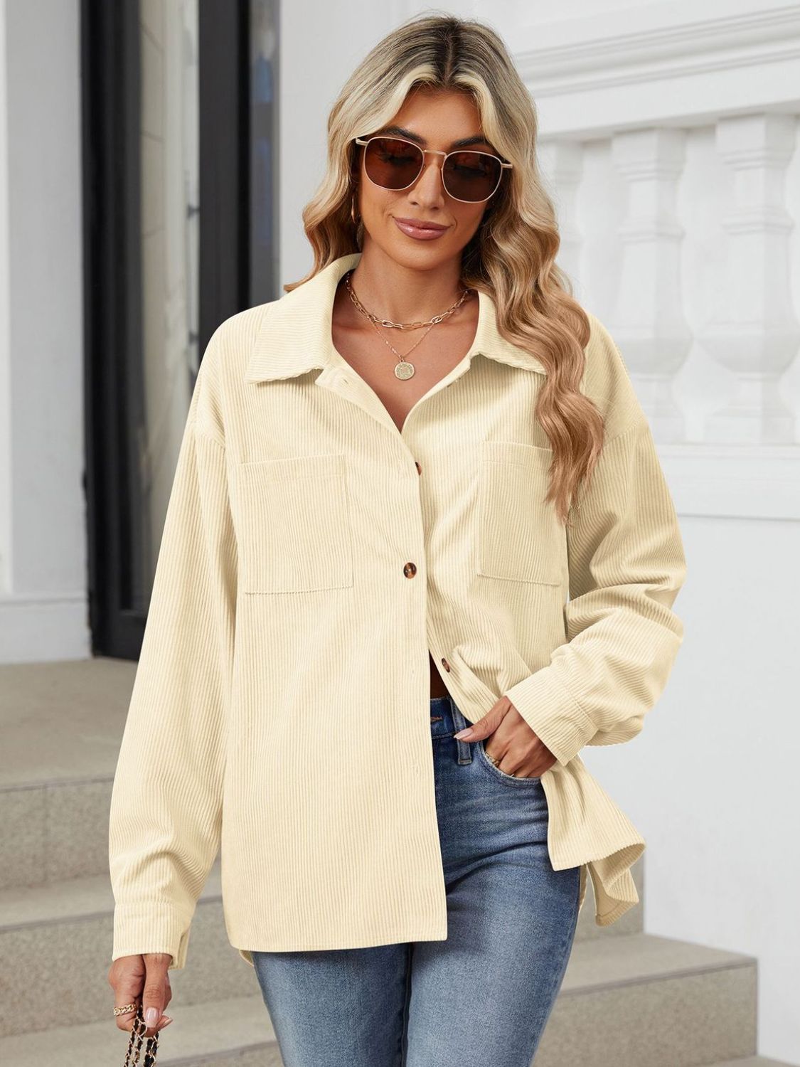 Cream corduroy overshirt with button front and chest pockets, long sleeves.