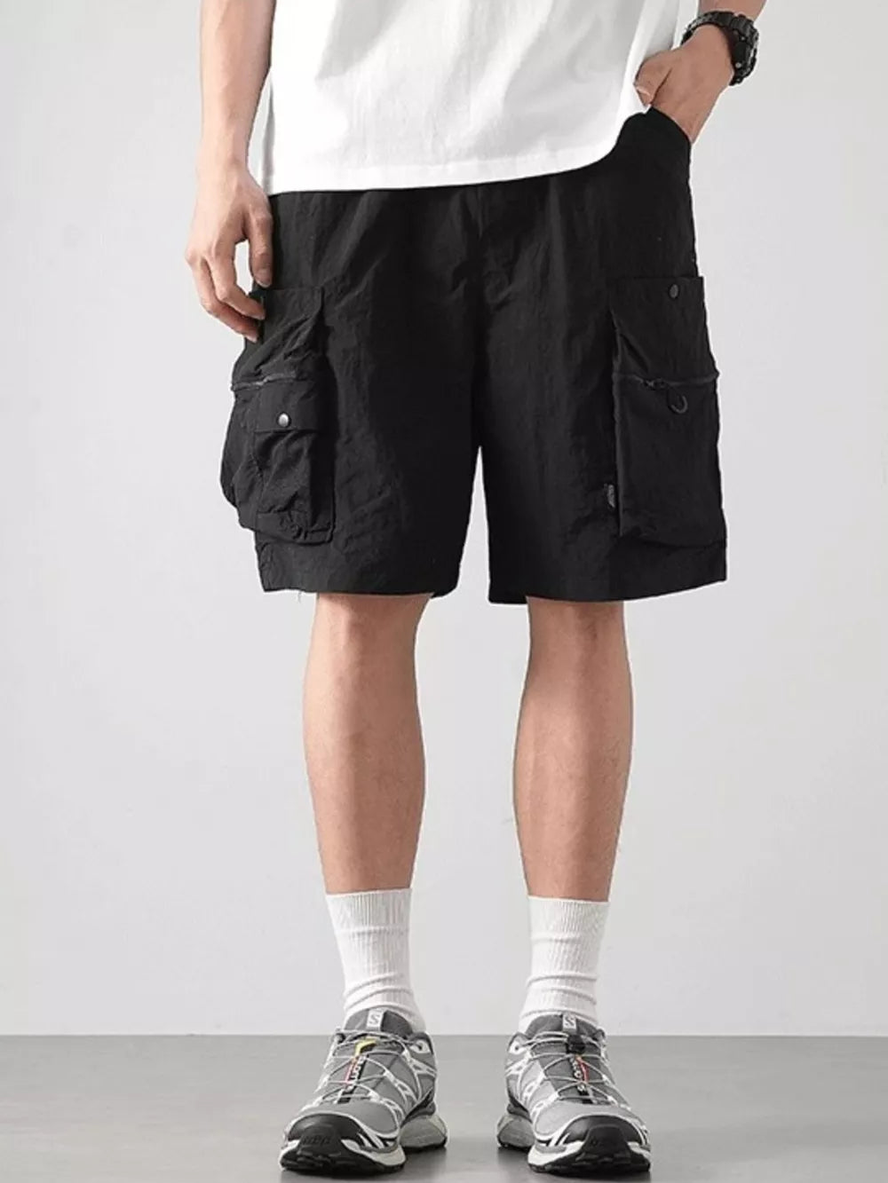 Black cargo shorts with multiple pockets and a relaxed fit.