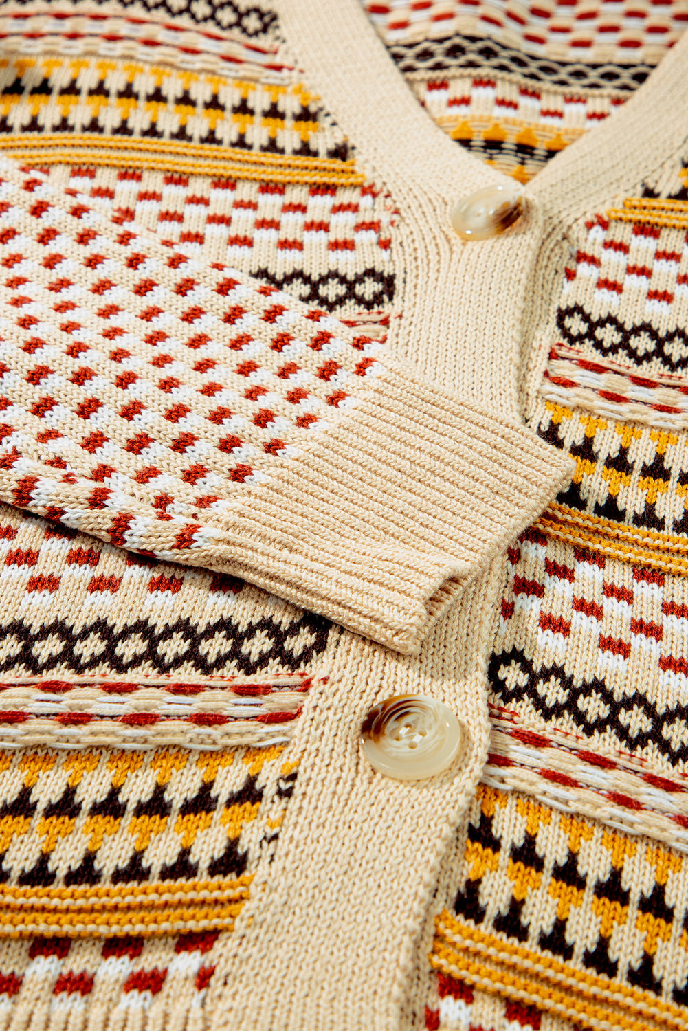 Geometric knit cropped cardigan in khaki with a V-neck, button front, and patterned acrylic fabric.