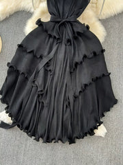 Black ruffled tiered midi dress with belted waist and frill trim.