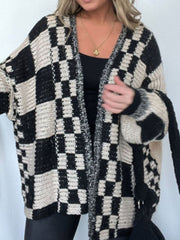 Oversized black and cream checkerboard knit cardigan with open front and textured details.