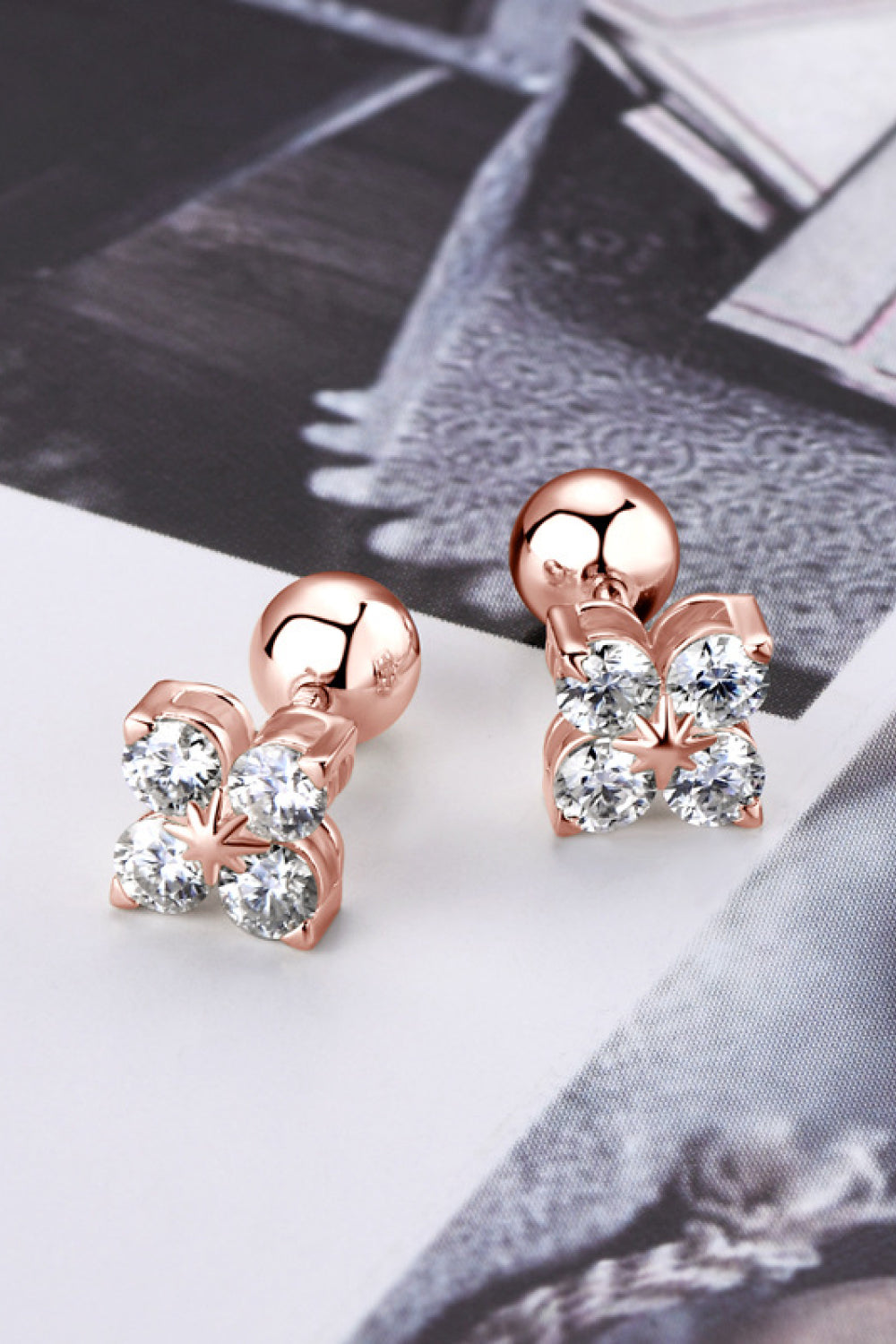 Rose gold stud earrings with four clear stones in a clover design