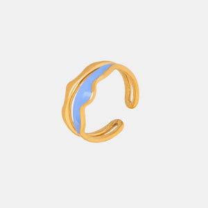 Gold wave ring with light blue enamel inlay, adjustable open band.