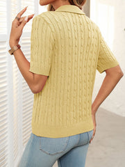 Turmeric cable knit polo sweater with short sleeves and a collar.