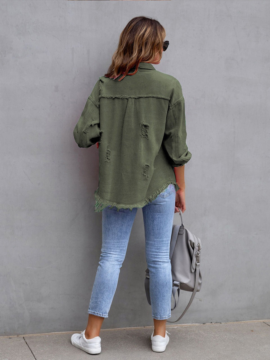 Moss green distressed denim shacket with frayed hem and cuffs.