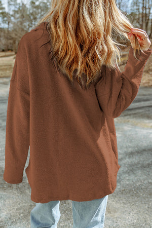 Brown textured shacket with raw-edge detailing and button closure.