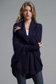 Navy batwing knit cardigan with drape front and textured sleeves.