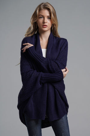 Navy batwing knit cardigan with drape front and textured sleeves.