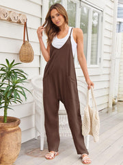 Relaxed brown pocketed overalls jumpsuit with V-neck and wide legs.