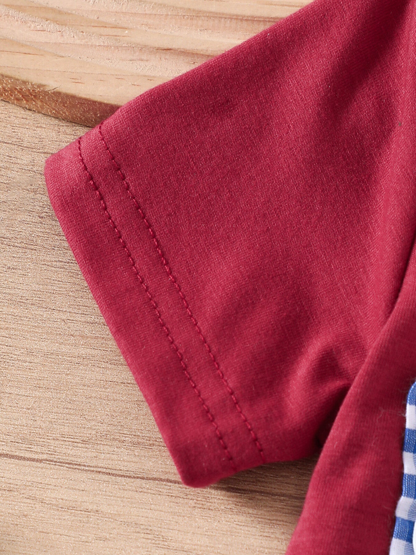 Maroon baby set with blue and white gingham trim and American flag embroidery detail.