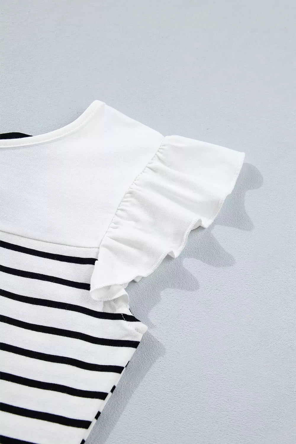 Striped cotton tank top with white ruffled cap sleeves and a white yoke.