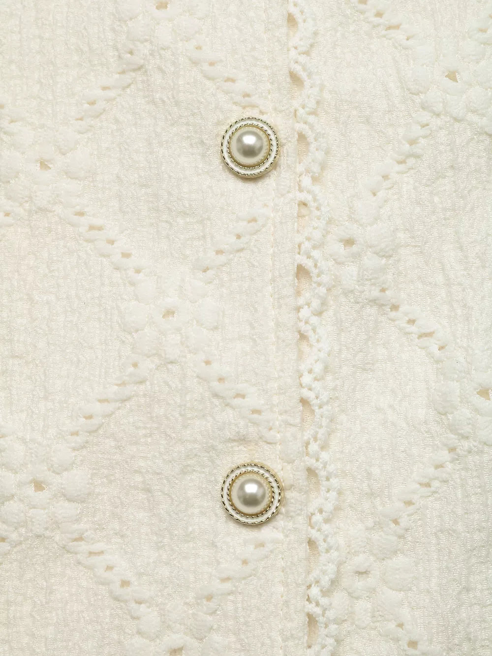 Textured cream maternity shirt with pearl buttons and lace trim detail.