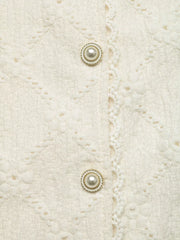 Textured cream maternity shirt with pearl buttons and lace trim detail.