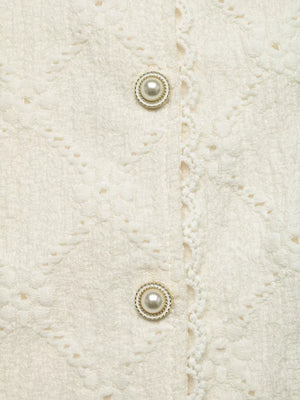 Textured cream maternity shirt with pearl buttons and lace trim detail.