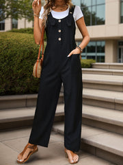 Black button-front wide-leg jumpsuit with pockets, styled with a white tee and sandals.