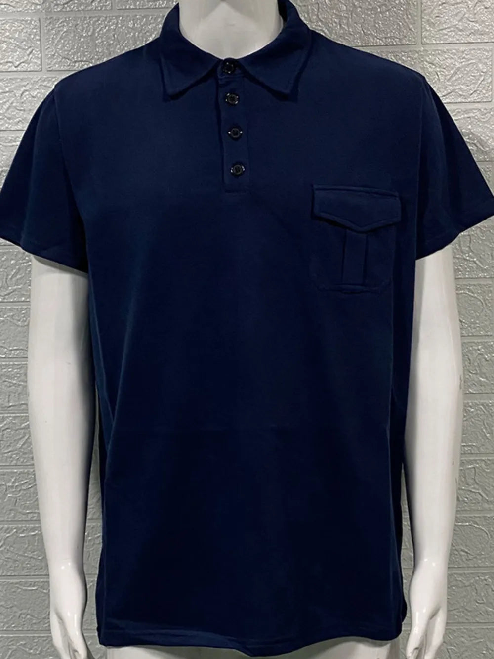 Navy utility pocket polo shirt with short sleeves and a button placket.