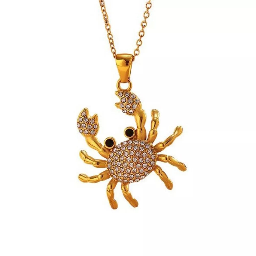 Gold-plated crab pendant necklace with crystal accents and a delicate chain.