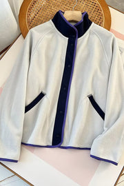 Light Gray fleece bomber jacket with navy and purple contrast trim and snap closure.
