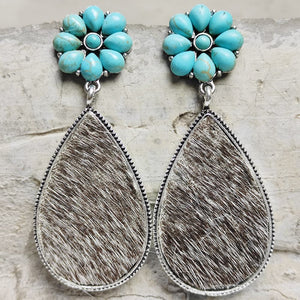 Turquoise petal flower earrings with brown and white cowhide teardrop dangles.