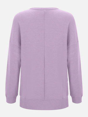 Lavender waffle knit relaxed fit crewneck top with long sleeves and a seam down the back.