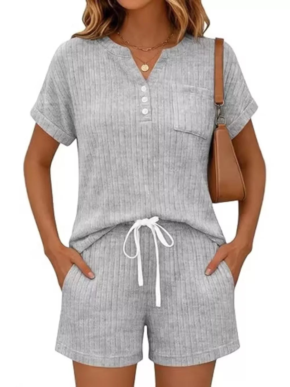 Light gray ribbed knit two-piece loungewear set with henley neckline and drawstring shorts.