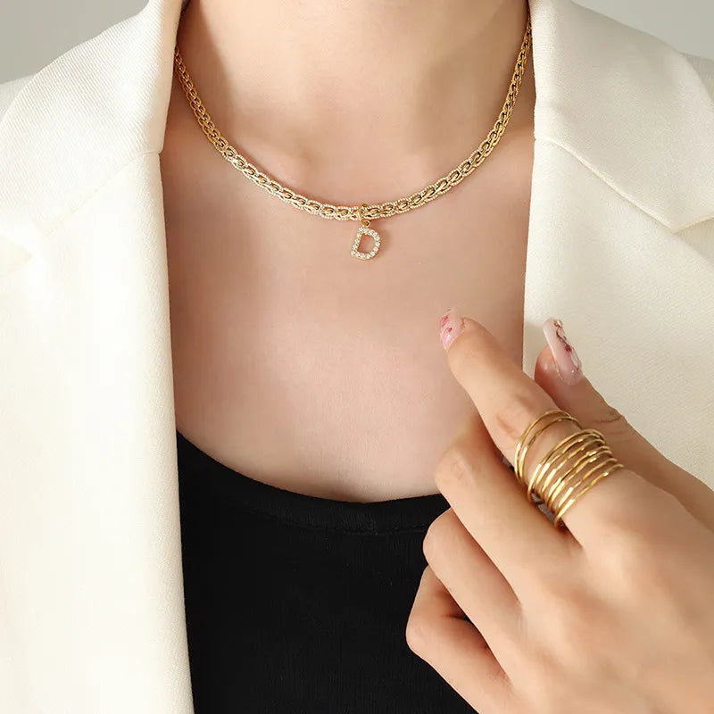 Gold chain necklace with a zircon-set initial D pendant