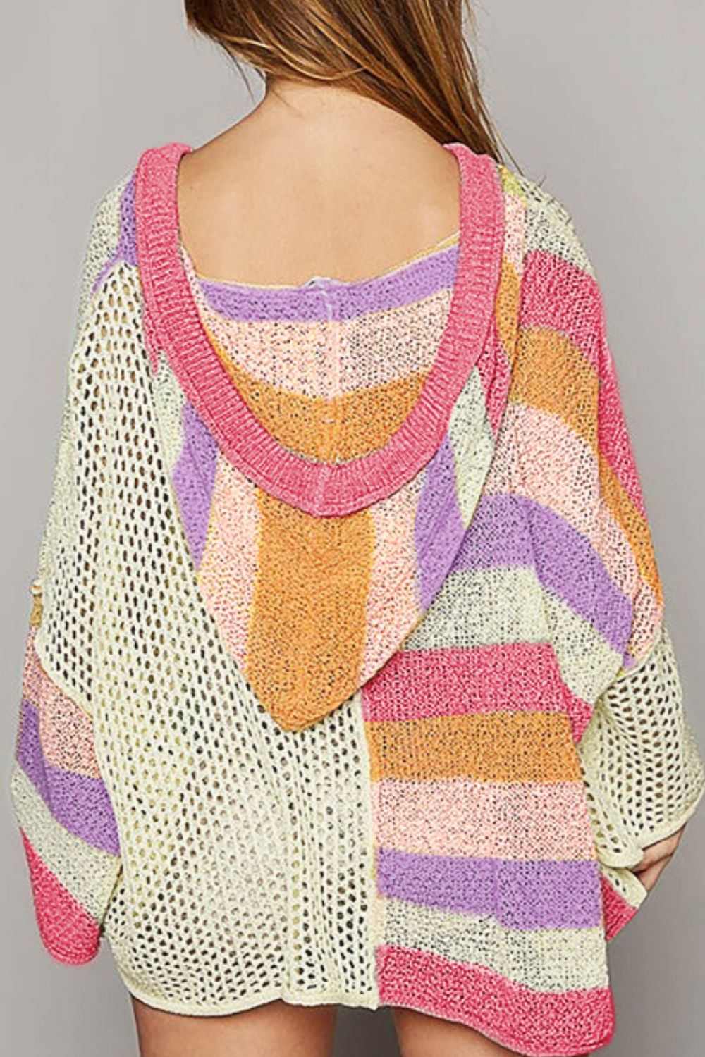 Colorblock knit hoodie with open knit panels and striped pattern in pink, purple, orange, and cream.