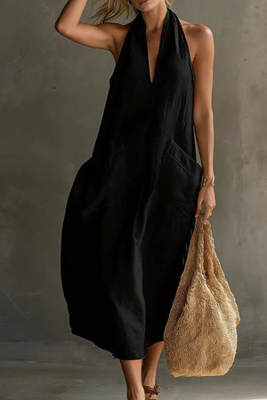 Black halter midi dress with deep V-neck and large front pockets.