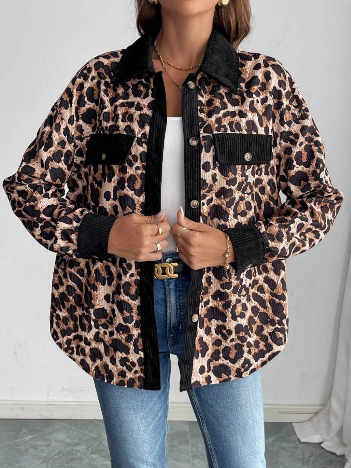Leopard corduroy utility shirt jacket with black accents and button front.
