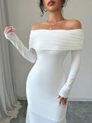 White off-shoulder bodycon maxi dress with draped neckline and long sleeves.
