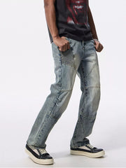 Men's light wash denim moto jeans with ribbed knee panels and wide leg.