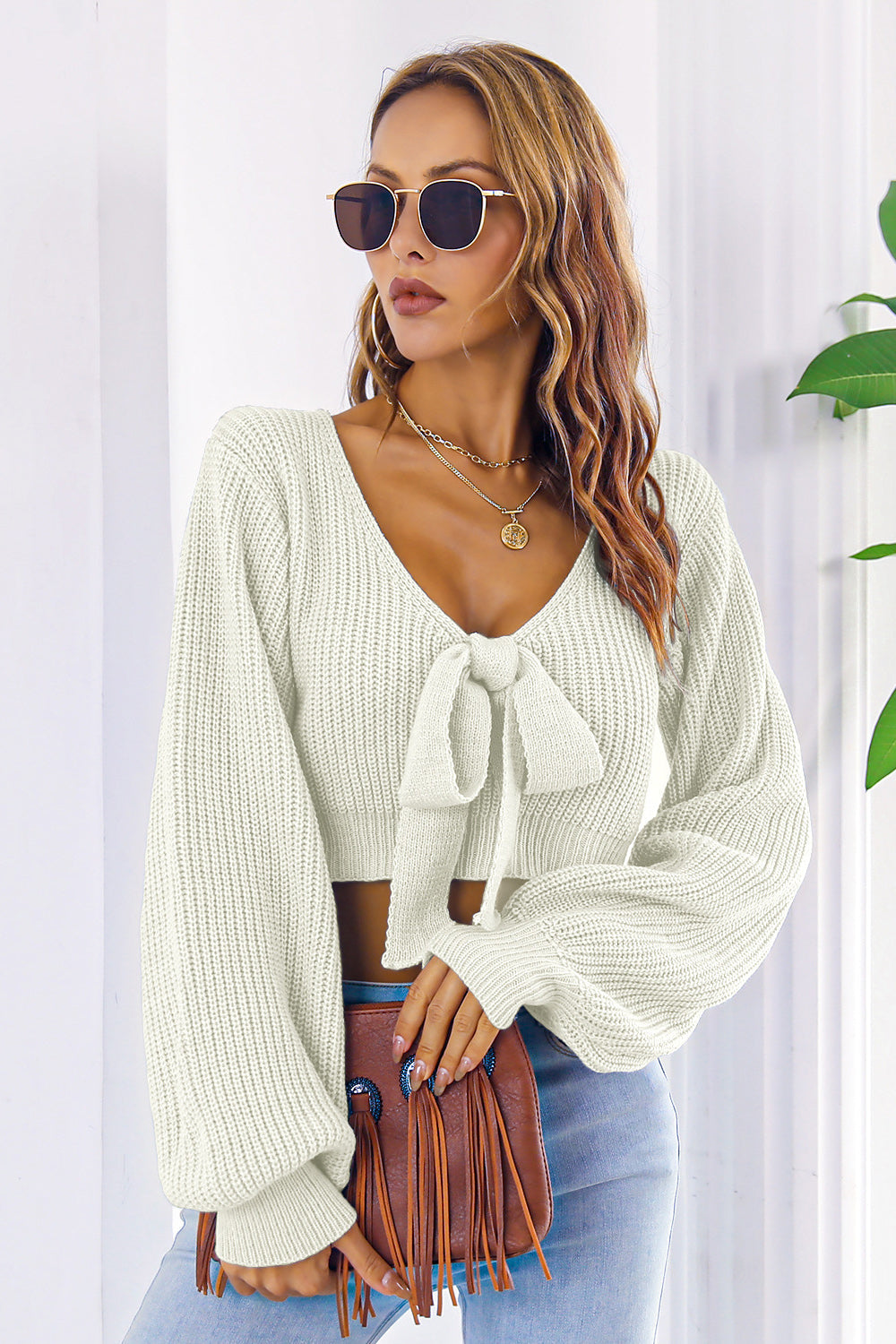 White acrylic tie-front crop sweater with balloon sleeves
