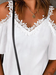 White polyester cold-shoulder blouse with lace trim neckline and flutter sleeves.
