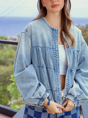 Washed denim zip-up jacket with tiered ruching detail and elastic cuffs.