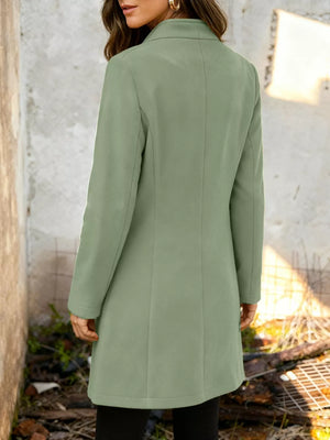Chic longline trench coat in Matcha Green with button-down detail and collarless neckline.