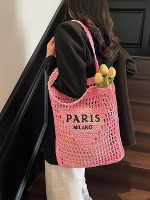 Pink crochet tote bag with PARIS MILANO graphic and open knit detail.
