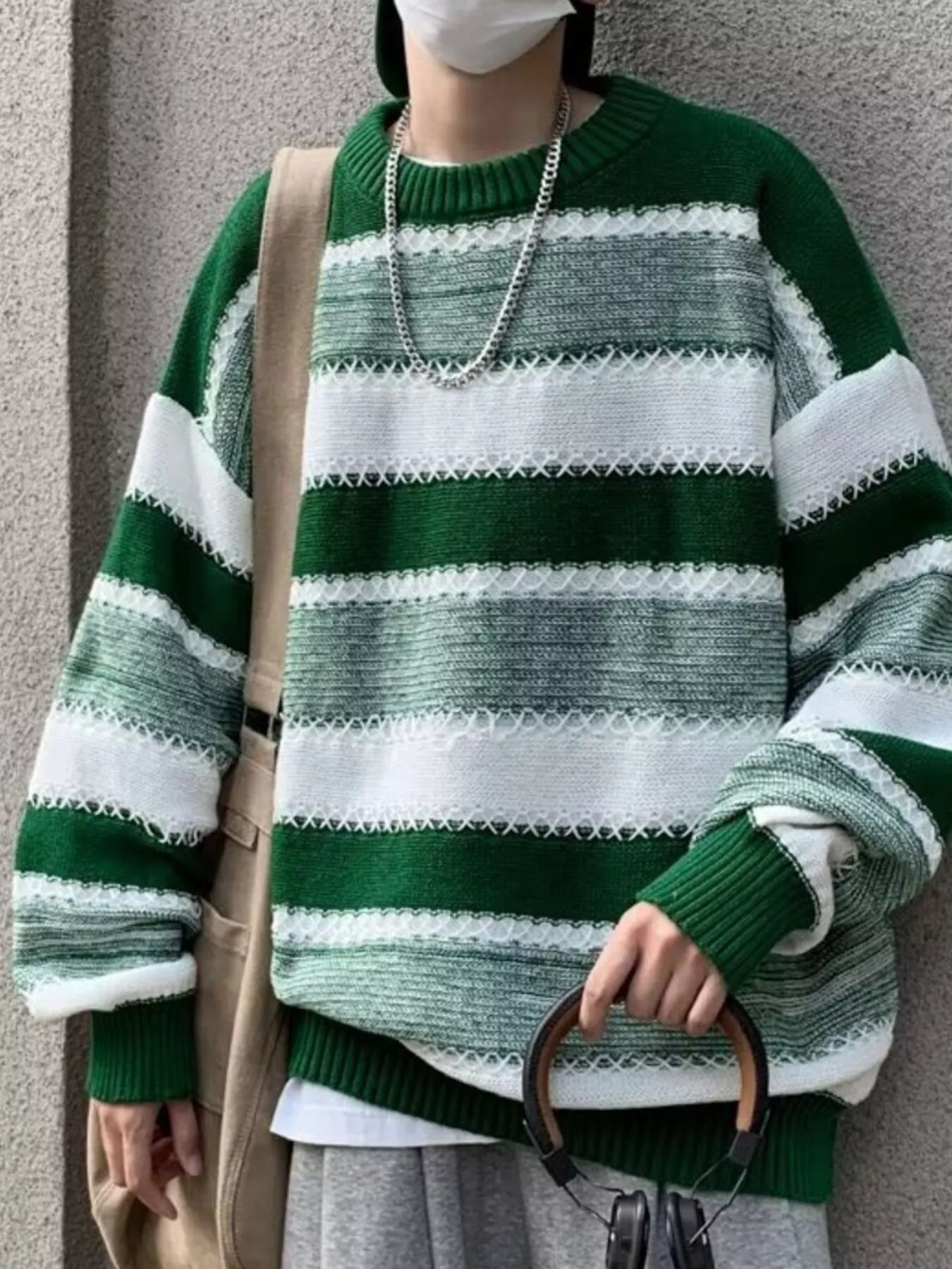 Relaxed fit green and white striped sweater with textured details and crew neck.