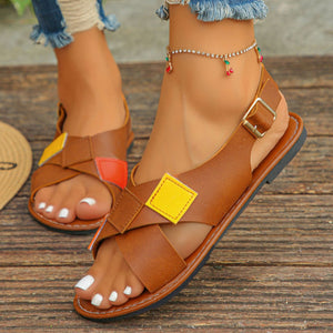 Brown ankle strap sandals with colorful patchwork detail and criss-cross straps.